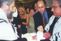 Baby on lap of sandek